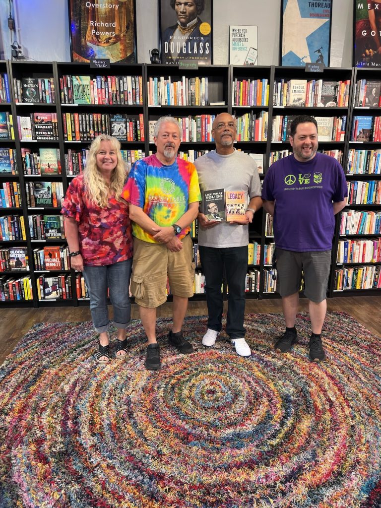 Round Table Bookstore owners l-r Donna Schultz, Scott Howard, and Andrew Howard with Dr. Jerry Doby (middle)
