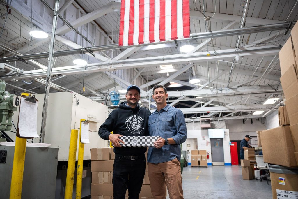 The Gift of Chess Founder and CEO Russell Makofsky with plant manager at manufacturing operation